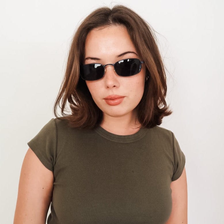 Model wearing Norbert trending 90s sunglasses with navy blue frame