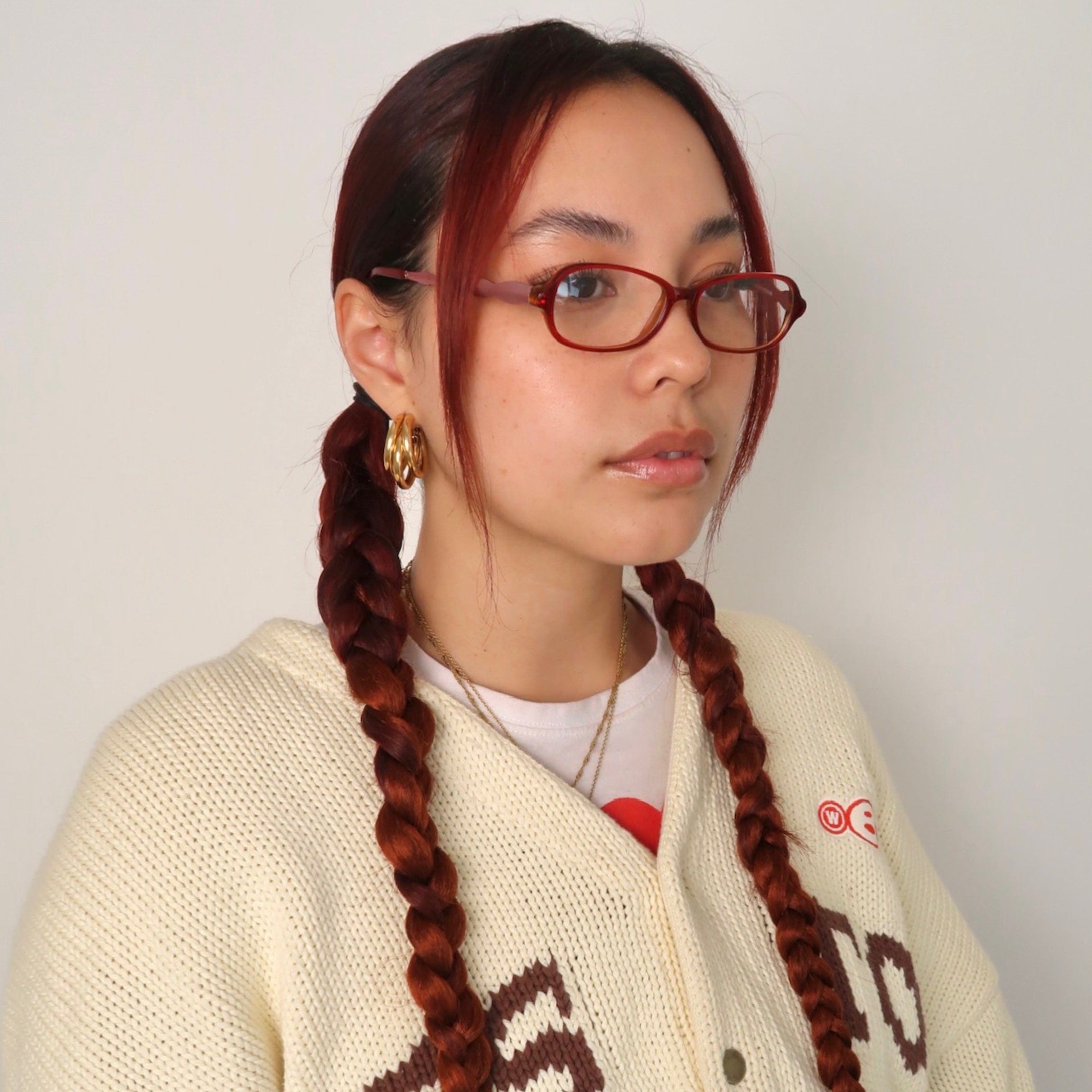 Model wearing cherry pop pink/Clear bayonetta style glasses