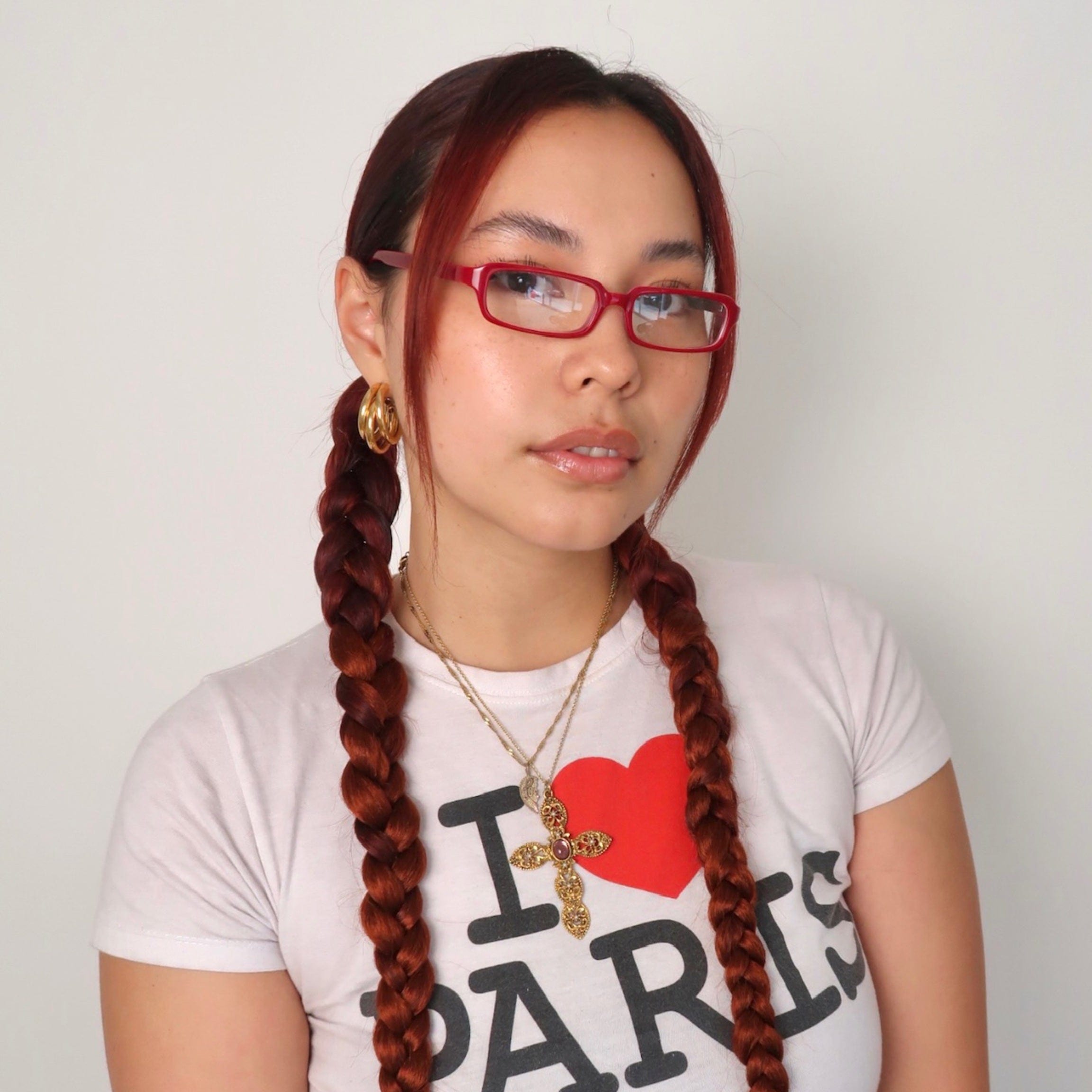 Model wearing ROJO slim bayonetta glasses with cherry color frame And clear lens