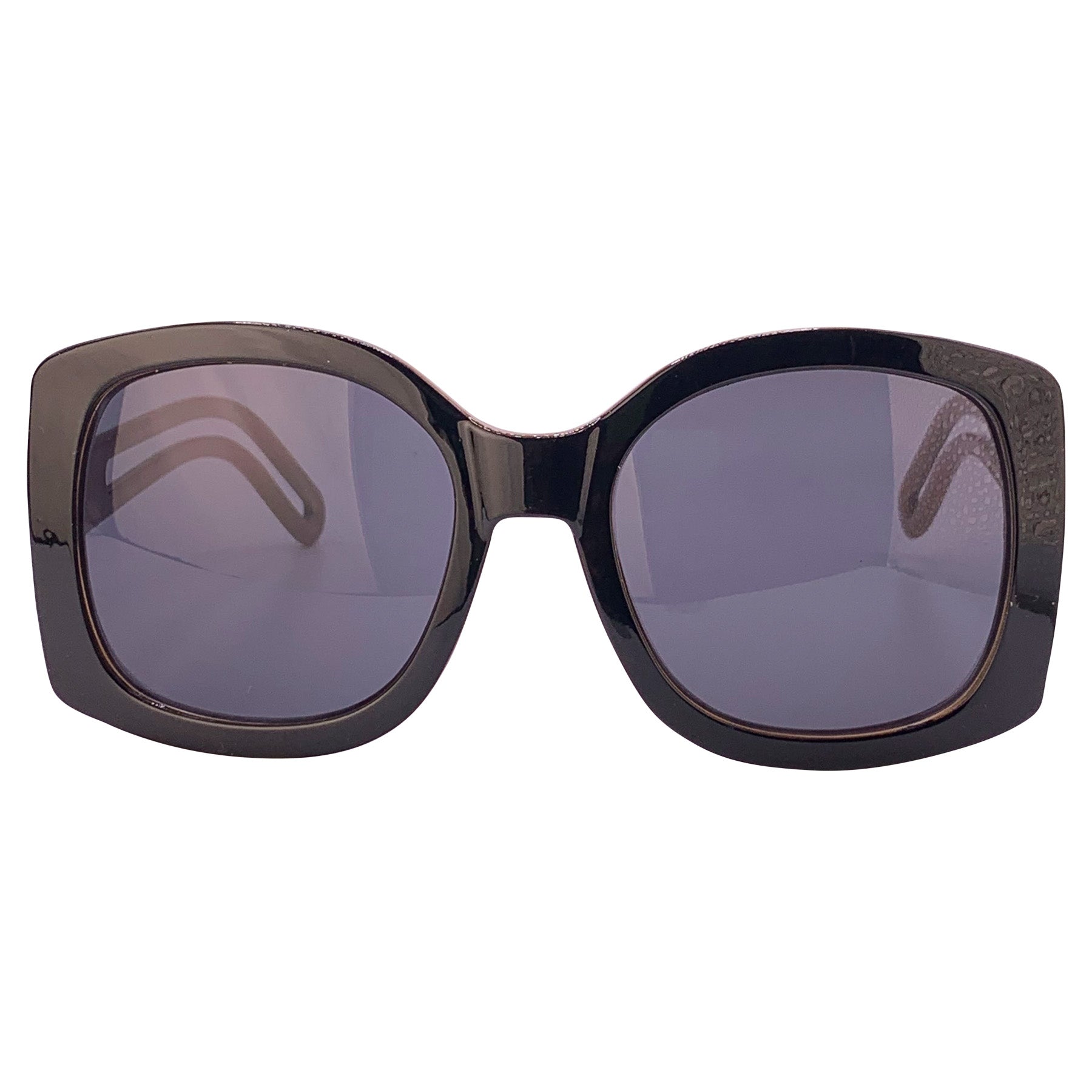 Oversized square boho sunglasses with a black outer frame, smoke lenses, and a brown inner frame, offering a stylish and trendy look for sunny days. Perfect for a chic, laid-back fashion statement.