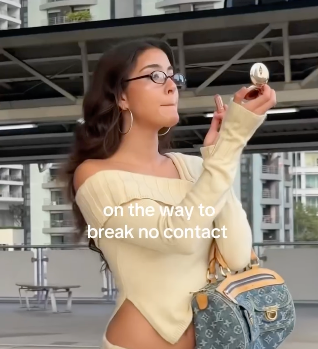 Instagram post showing a model in Giant Vintage glasses and checking her makeup in a compact mirror