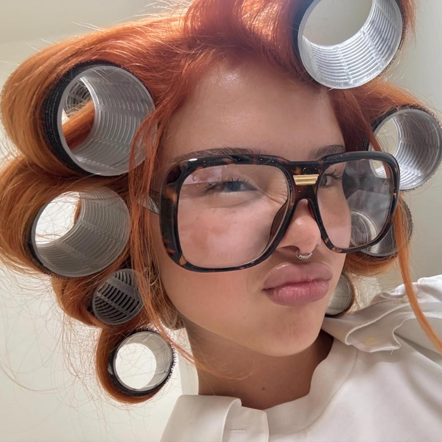 woman wearing oversized clear glasses in an instagram post